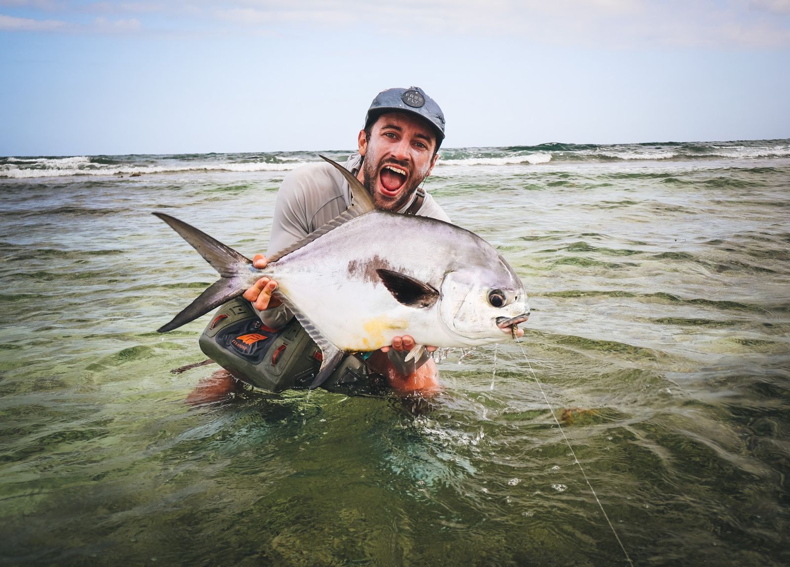Jack Shirk, founder of Flood Tide Digital, holding a permit on the flat